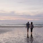 A couple walking on the beach during the Fall Season in Gulf Shores, Alabama